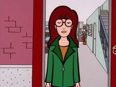 a woman with red hair and glasses standing in front of a doorway