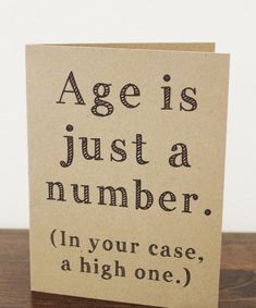 a card with the words age is just a number in black ink on top of it