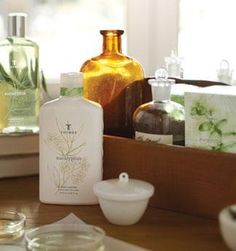 various bottles and containers on a table with soap, lotion, and other items