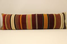 a striped pillow sitting on top of a white table