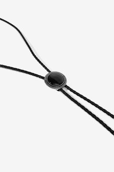 THE WESTERN BOLO TIE. Inject a hint of western spirit into any outfit with this Black Stone Bolo Tie. Crafted from 100% Braided Leather Rope and featuring stainless steel tips.  

Pair with any of our Flannel shirt for a more traditional look or over a Vintage Tee for a modern take. Adjustable Black Bolo Ties For Rodeo, Adjustable Black Bolo Tie For Rodeo, Black Adjustable Bolo Ties For Rodeo, Black Western Bolo Tie With Concho, Western Black Bolo Ties For Western-themed Events, Black Stone Pendant, Western Bolo Tie, Bolo Tie, Vintage Tee