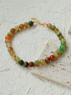 Elevate your summer style with our Multi-Colored Gemstone Beaded Necklace! Handcrafted with intricate beads, this necklace features multi-colored agates strung together to create an array of vibrant colors that complement any outfit, bringing out the color of summer and giving a cool feel. This versatile and stunning necklace will add a touch of luxury to any look. Metal: 18K Recycled Gold Plated On Brass Gemstone: Multicolor Onyx 12mm Length: 390-430mm Weight: 62g Gold Jade Beaded Necklaces With Round Beads, Gold Jade Round Beaded Necklaces, Elegant Agate Beaded Necklaces With Colorful Beads, Elegant Agate Necklaces With Colorful Beads, Elegant Colorful Agate Beaded Necklaces, Elegant Agate Beaded Necklace, Elegant Green Onyx Beaded Necklaces, Elegant Agate Beaded Bracelet With Colorful Beads, Green Onyx Gemstone Beaded Necklaces With Round Beads