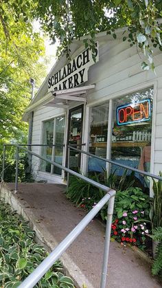 the entrance to schaach's bakery with plants and flowers