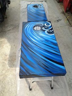 a table painted with blue and black swirls