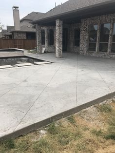 an empty concrete patio in front of a house