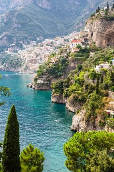 the coast is lined with trees and houses on it's sides, overlooking the water