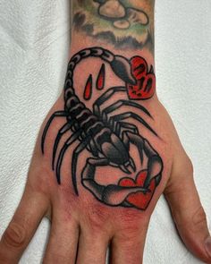 a man's hand with a tattoo on it and a scorpion in the middle