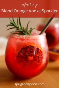 blood orange vodka spritkle in a glass with rosemary garnish