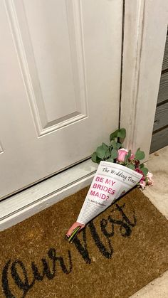 an upside down umbrella sitting on the ground next to a door with writing written on it