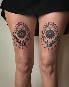 a woman's legs with black and white tattoos on her thighs, both showing