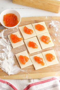 small pieces of food sitting on top of a wooden cutting board