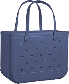 a blue tote bag with holes on the front and side, sitting in front of a white background