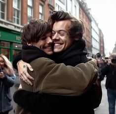 two men hugging each other on the street