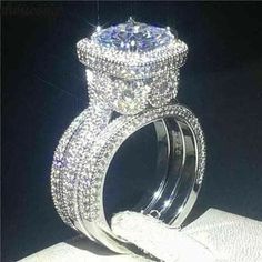 a diamond ring with two rows of diamonds on it, sitting next to each other