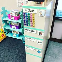 a toy cash register sitting on top of a blue floor next to a book shelf