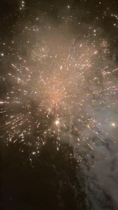 fireworks exploding in the night sky with lots of lights on it's sides and dark background