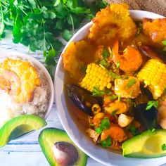 a white bowl filled with food next to two bowls of rice and veggies