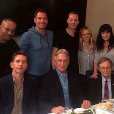 a group of people sitting around a dinner table