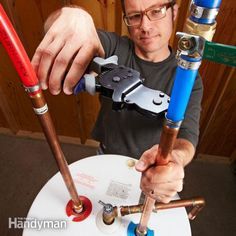 a man is working on some kind of pipe fitting machine that he's holding