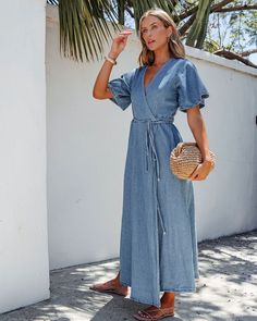 Crafted from high-quality denim, this maxi dress features a stylish wrapped front design! Perfect for a casual day out or a special occasion, this dress offers both comfort and a flattering silhouette. Style with comfy sandals, gold jewelry, and a chic crossbody bag for an elevated date night look. Spring V-neck Medium Wash Denim Dress, Spring Medium Wash Maxi-length Denim Dress, V-neck Denim Blue Dress With Button Closure, Blue Chambray Denim Dress - Relaxed Fit, Chic Crossbody Bag, Non-stretch Medium Wash Denim Dress With Button Closure, Destructed Jeans, Comfy Sandals, Loungewear Dresses