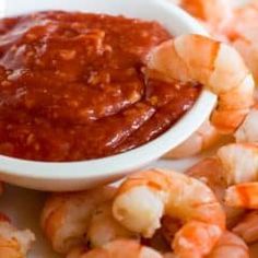 a plate with shrimp and dipping sauce on it