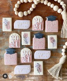 decorated cookies with graduation caps and tassels are arranged on a wooden table,