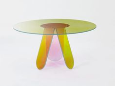 a glass table with an abstract design on it's top and bottom, against a white background