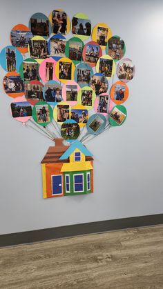 a family tree with pictures on it hanging from the side of a wall next to a wooden floor