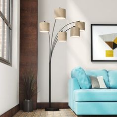 a living room with a blue couch and floor lamp