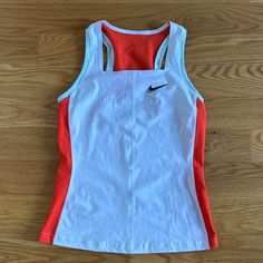 a women's nike tank top on a wood floor with the back side cut out