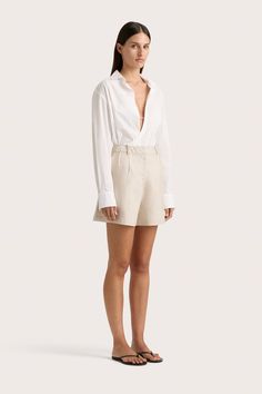 A classic oversized button-up shirt with a wrap front tie closure. Cut from a crisp 100% organic cotton, it is both transeasonal and versatile in styling, making for the perfect addition to your capsule wardrobe. Wear tucked into or over a relaxed trouser or short, like the Antibes Short, for year-round wear. Chic Cotton Blouse With Lapel Collar, Timeless Summer Button-up Tops, Timeless Button-up Summer Top, Timeless Summer Blouse For Work, White Lapel Collar Top For Day Out, Timeless Summer Blouse For Workwear, White Tops With Lapel Collar For Day Out, Chic White Shirt With Lapel Collar, Timeless Cotton Blouse