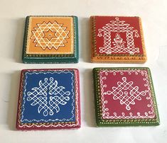 four different colored coasters with designs on them