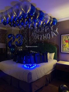 a bed room with a neatly made bed and balloons