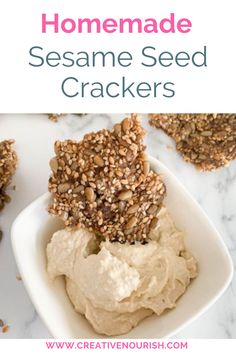 homemade sesame seed crackers in a white bowl on a marble counter with text overlay