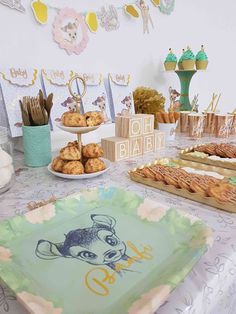 a table topped with lots of food and desserts on top of it's tables