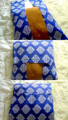 two pieces of blue and brown fabric on a white bed with the top half folded up