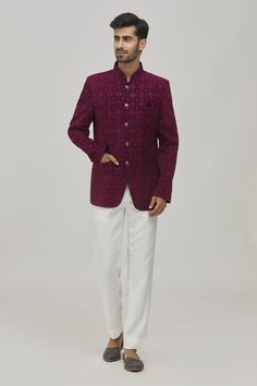 Wine bandhgala with floral pattern thread and sequin embroidery. Comes with contrast white trouser.
Components:2
Pattern:Embroidered
Type of Work:Thread, Sequins
Neckline:Mandarin Collar
Sleeve Type:Long
Fabric:Velvet, TR
Color:Wine
Other Details:
Welt pocket in front
Trouser waistband with belt loops
Button detailing on the sleeve hems
Closure:
Bandhgala: Button front
Trouser: Hook and fly front
Note: The pocket square worn by the model is not for sale
Occasion:Cocktail and Reception - Aza Fash Elegant Nehru Jacket With Mirror Work For Festive Occasions, Elegant Festive Bandhgala With Mirror Work, Elegant Nehru Jacket With Mirror Work For Transitional Season, Elegant Nehru Jacket With Mirror Work For Festivals, Elegant Nehru Jacket With Mirror Work For Formal Occasions, Elegant Nehru Jacket With Mirror Work For Formal Events, Festive Formal Sherwani With Mirror Work, Formal Transitional Traditional Wear With Mirror Work, White Festive Bandhgala For Party