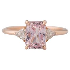 Introducing our exquisite 14K Rose Gold 3-Stone GIA Radiant Cut Peach Sapphire Ring, a mesmerizing blend of elegance and charm! Featuring a stunning GIA-certified 2.54 Ct center stone, measuring 7.91x5.89x4.97MM, this natural and unheated beauty is a true marvel of nature. Flanked by two dazzling trillion cut diamonds totaling 0.32 carats each measuring 3.9x3.7MM, this ring sparkles with sophistication. Crafted to perfection and ready to impress, this eternal piece is sure to captivate hearts an Peach Sapphire Rings, Sapphire Diamond Engagement Ring, Diamond Sapphire Engagement Ring, Sapphire Diamond Engagement, Peach Sapphire, Sparkling Rings, Radiant Cut, Three Stone Rings, Belleza Natural