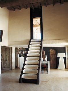 a staircase made out of white pillows in a living room