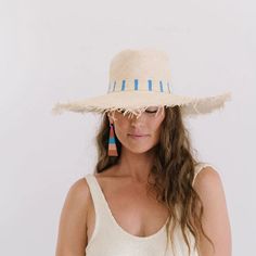 The Susana Wide Brimmed Palm Fringe Hat features a cotton woven band with blue and white stripes with a fringe wide brimmed. Each one is handmade from palm fronds of the banks of the Chixoy River by our Guatemala female artisans. This hat collection is both sustainable and a fair trade partnership. With every hat purchase you make, we are able to continue sending orders to our talented partners giving them the means to support their families. Details: Permanent woven band attached to crown of ha Fringe Hat, Pink Terracotta, Striped Earrings, Palm Fronds, Light Coral, Holiday Earring, Pop Up Shops, Women Artisans, Natural Material