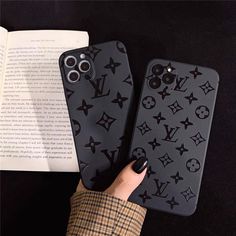 two cases with louis vuitton on them are next to an open book