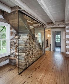 an empty room with wood and glass in the wall, along with wooden flooring