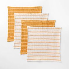 three orange and white striped knitted placemats