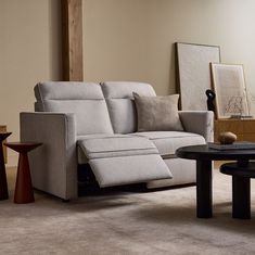 a living room scene with focus on the reclining couch and coffee table in the foreground