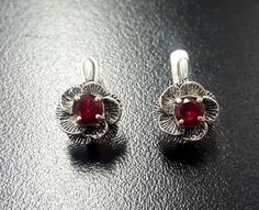 Red Rose Earrings set with Created Ruby in a top quality, perfect diamond cut & flawless clarity, at 5mm each (1.2 Ct a pair)Solid 925 Sterling Silver ☞ made to last. Click here for ☞ Matching Pendant Click here for ☞ Matching Ring Details:• Created Ruby in a flawless clarity• Ruby: 5mm each, 1.2 Ct a pair, diamond cut• Lever Back Closure - "English Lock"• Dimensions: Length 18mm, Width 11mm• Solid 925 Sterling SilverSKU 2316 Red Rose Earrings, Ruby Flower, Red Flower Earrings, Matching Ring, Sapphire Pendant, Ruby Earrings, Earrings Dainty, Red Earrings, Matching Rings