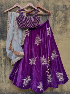 This stunning purple velvet lehenga with big golden hand embroidery buttis is teamed with purple velvet blouse in zardosi and sequin linear embroidery. This outfit is complete with an ivory net hand buttis work dupatta with scallop border. Purple Velvet Lehenga, Purple Velvet Blouse, Ivory Dupatta, Linear Embroidery, Velvet Blouse Design, Purple Lehenga, Dance Style Outfits, Ethnic Beauty, Lehenga Saree Design