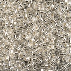 an image of many metallic beads on a white surface