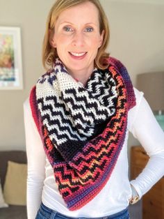 a woman wearing a multicolored knitted scarf