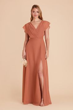 a woman wearing an orange bridesmaid dress with a slited skirt and side slit