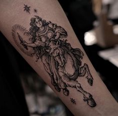 a black and white tattoo on the arm of a woman with an angel flying over her head